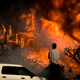 A man watches flames consume a home in Ventura. (Image: AP)